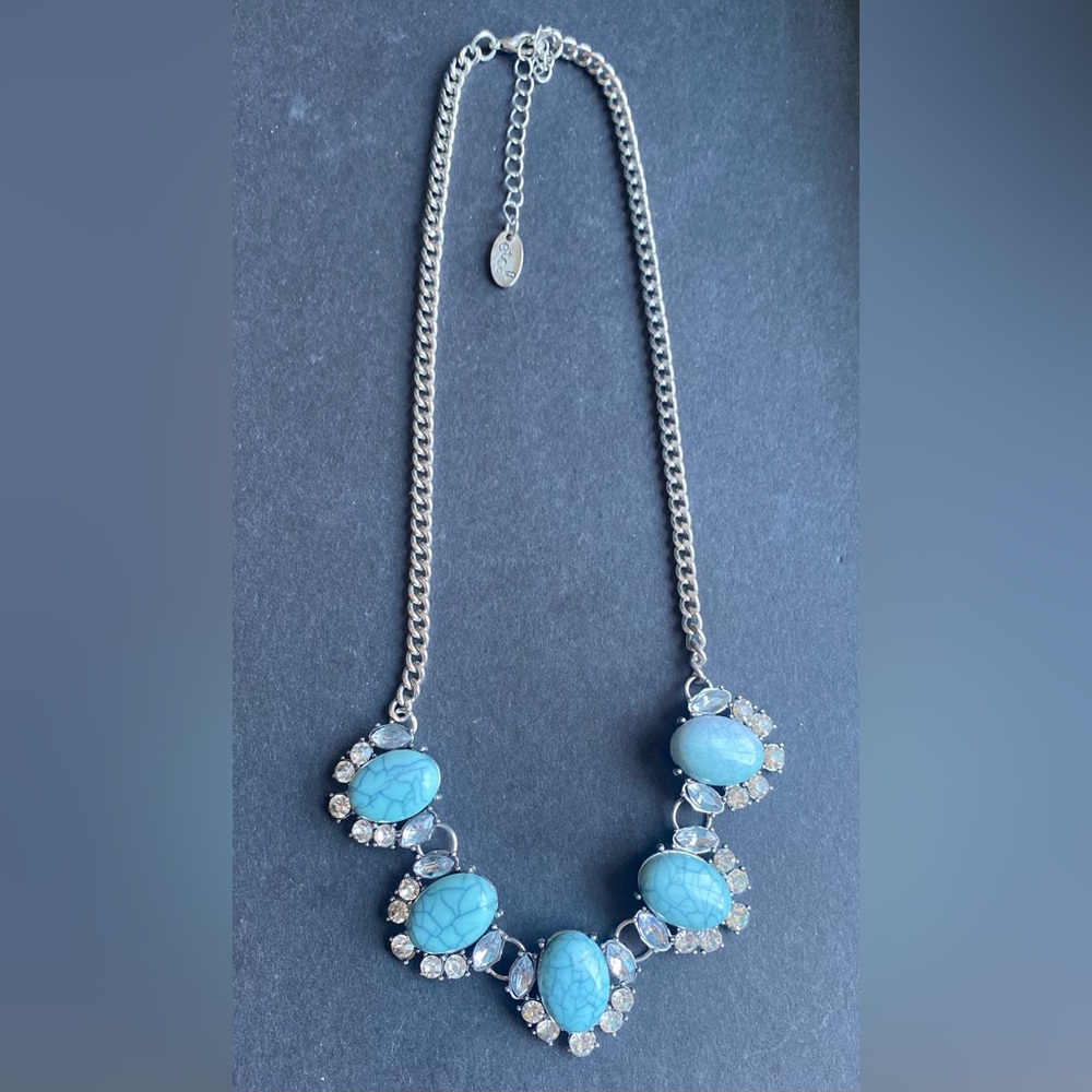 Silver toned statement necklace with rhinestone and blue stone accents